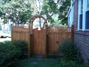 White Cedar privacy fence style berkshire with square lattice top includes cedar arbor with custom gate