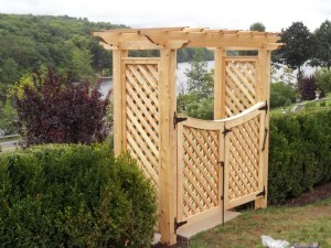 White cedar pergola with custom scalloped gate