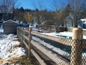 cedar 3 rail post and rail fence with security mesh for pool enclosure.